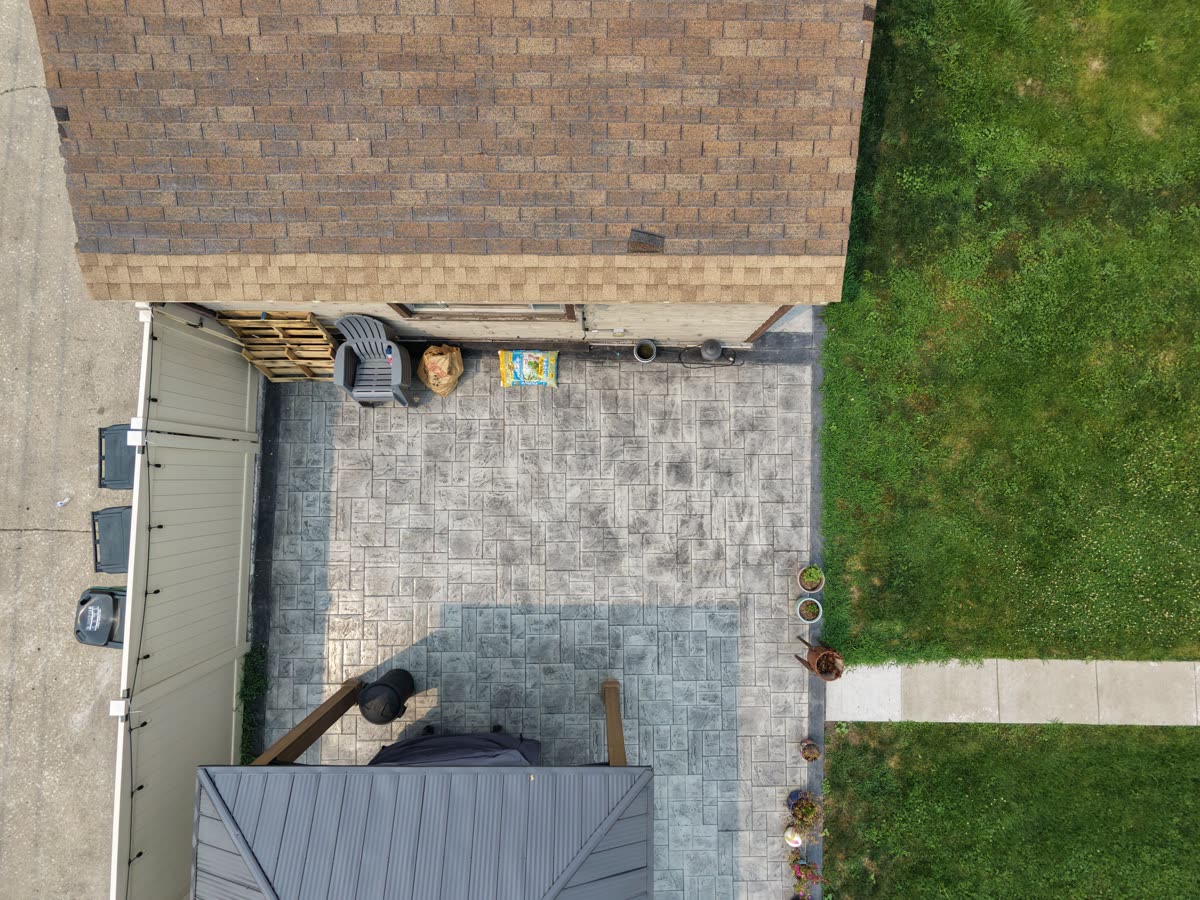 Aerial shot showing the property yard in context with the surrounding neighborhood