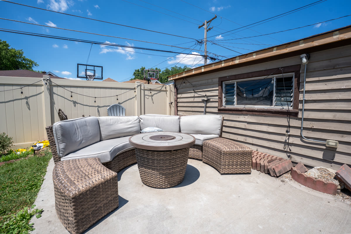 Ground-level HDR photo of a backyard patio seating area