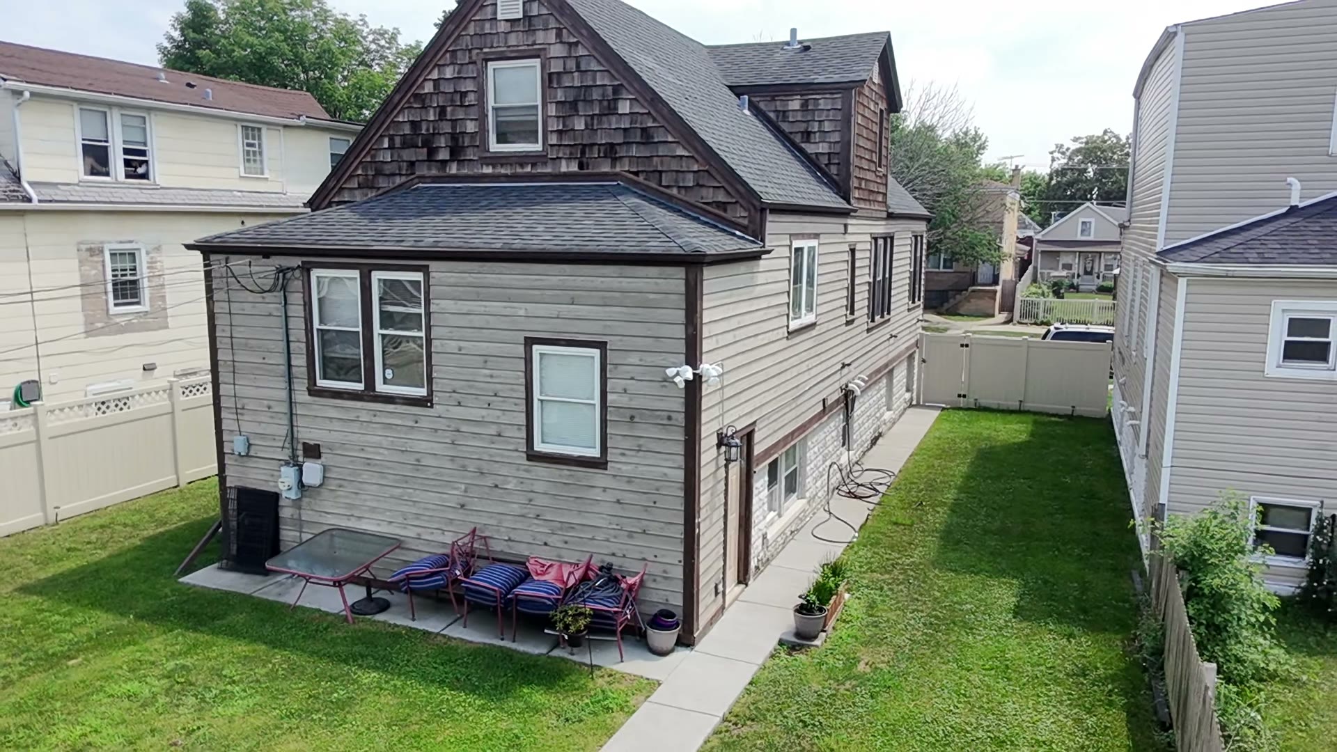 Aerial flyaround of a two-story home exterior — video thumbnail